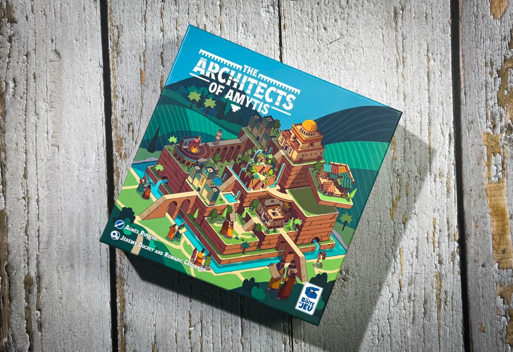 Architects of Amytis board game components and tile layout<br />
Architects of Amytis 3x3 city grid with stacked tiles<br />
Architects of Amytis favor board and pattern cards