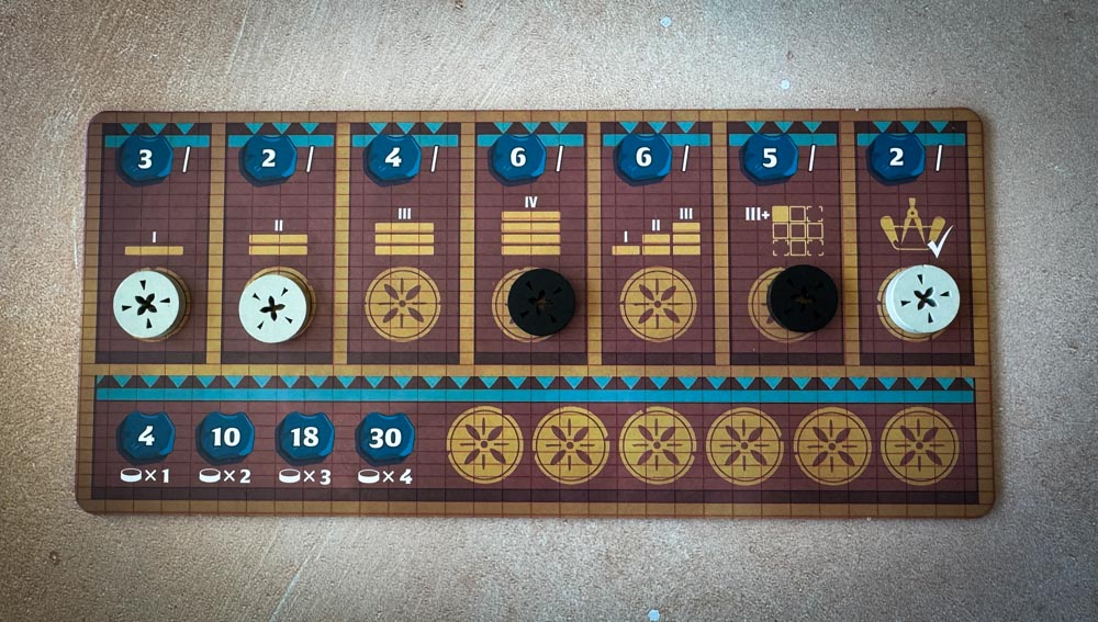 Architects of Amytis board game components and tile layout Architects of Amytis 3x3 city grid with stacked tiles Architects of Amytis favor board and pattern cards