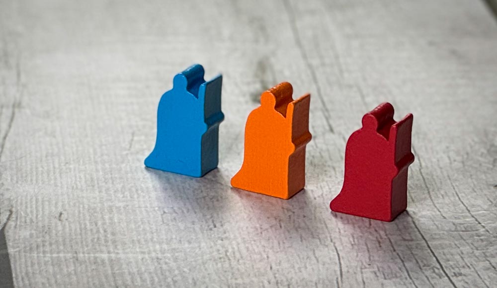 Rumian board game components showing medieval kingdom theme with wooden meeples