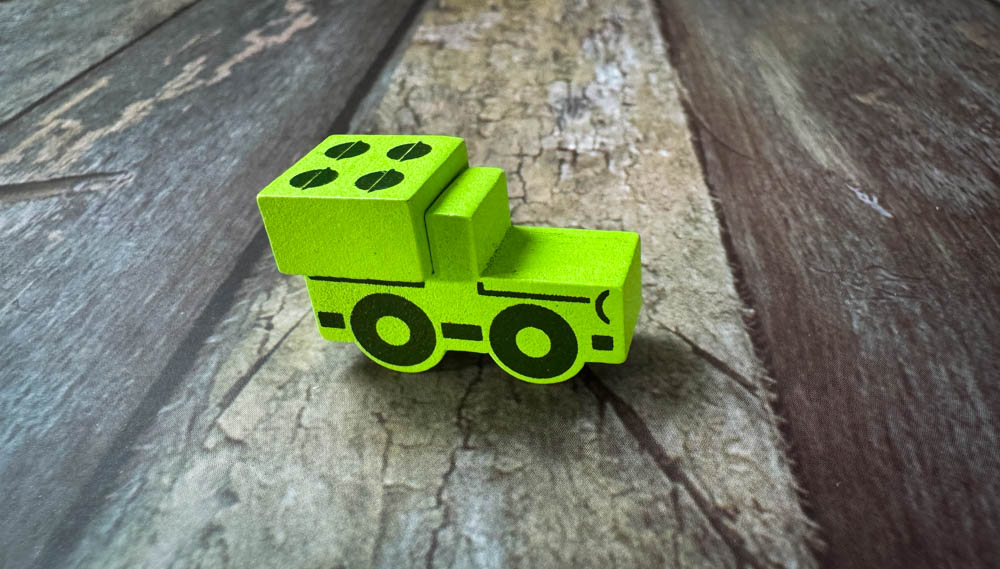 Gruntz board game components showing wooden meeples, magnetic vehicle attachments, and compact game board with WWII tactical gameplay elements - Wooden truck with Magnetic spawpoint attachment<br />
