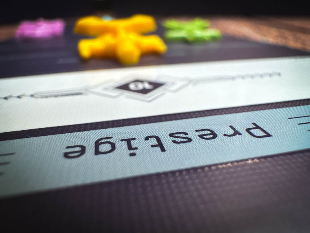 Moonrakers board game review showing deck building cards, contract missions, and player boards with ship upgrades in a space mercenary setting