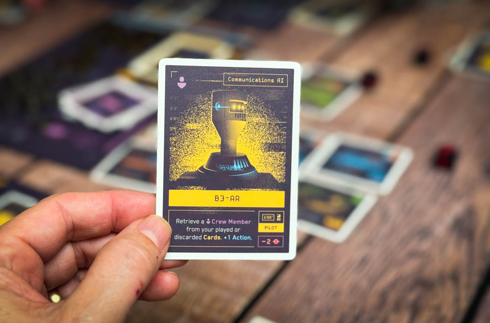 Moonrakers board game review showing deck building cards, contract missions, and player boards with ship upgrades in a space mercenary setting