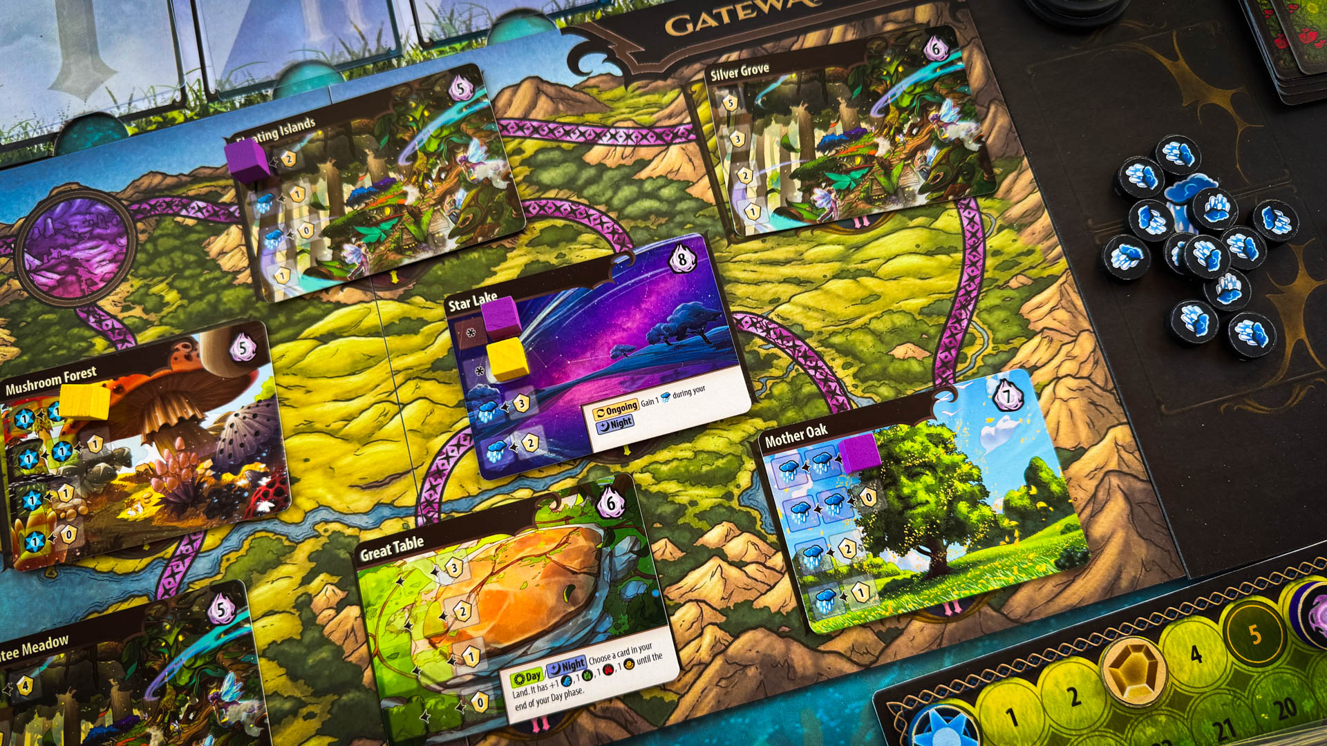 Mystic Lands board game with stained glass card art and Vale Map journey board