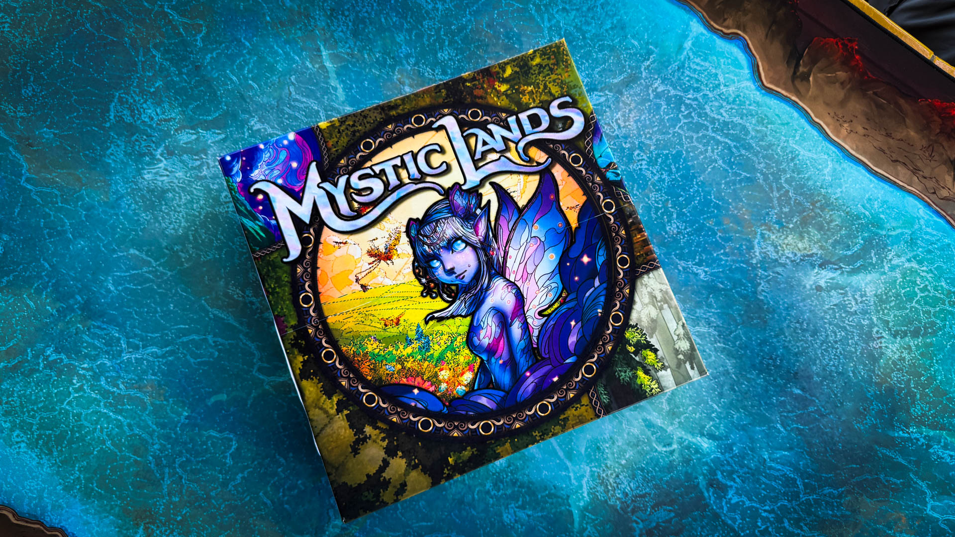 Mystic Lands board game with stained glass card art and Vale Map journey board